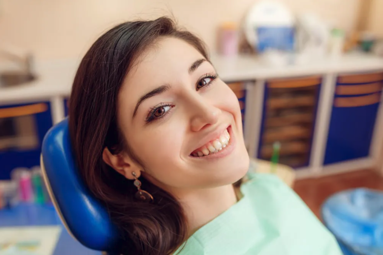 young woman in dental chair smiling